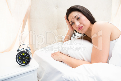 Pretty brunette waking up on bed