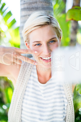 Pretty blonde woman taking selfie