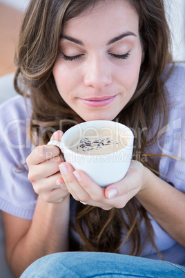 Pretty woman drinking cup of coffee
