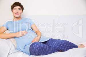 Pregnant woman relaxing on the couch