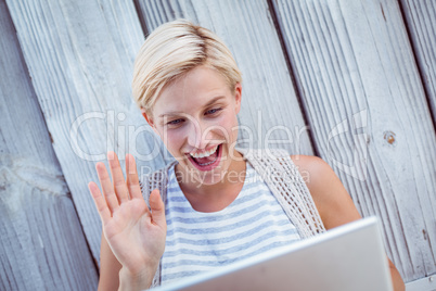 Pretty blonde woman speaking with someone online