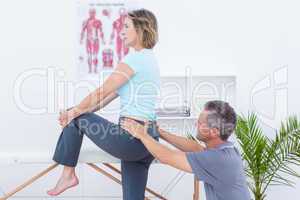 Physiotherapist examining his patient back