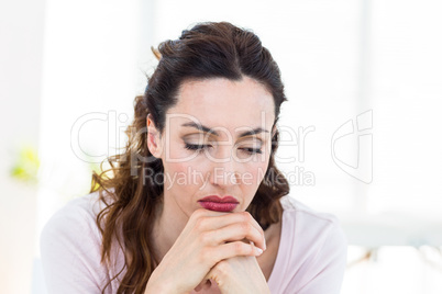 Upset brunette sitting on the couch