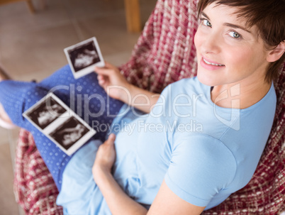 Pregnant woman looking at ultrasound scans