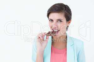 Pretty woman eating bar of chocolate