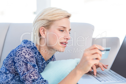 Pretty blonde woman doing online shopping