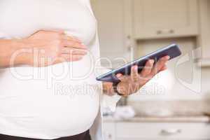 Pregnant woman using tablet pc