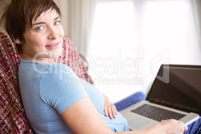 Pregnant woman using her laptop