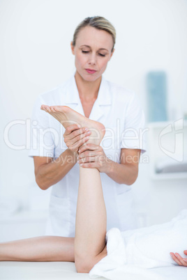 Physiotherapist doing foot massage