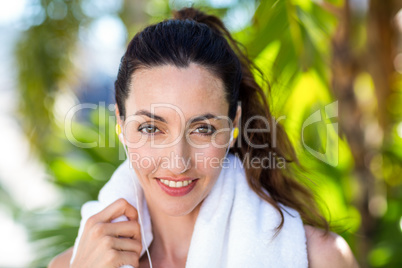 Fit beautiful brunette looking at camera while listening music