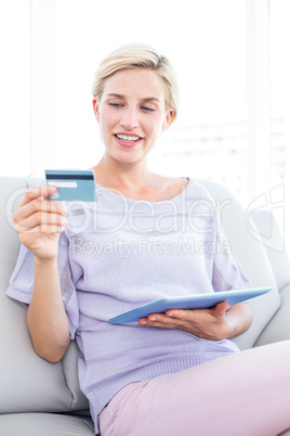 Pretty blonde woman doing online shopping