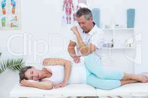 Doctor massaging his patient hip