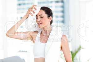 Brunette wiping her forehead with towel