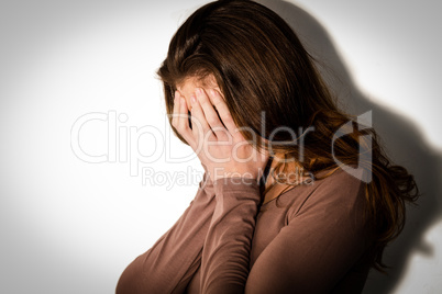 Depressed woman with head in hands