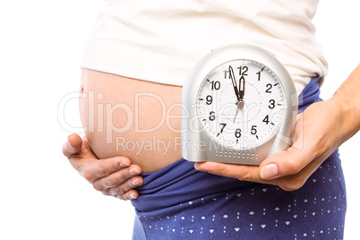 Pregnant woman showing clock and bump