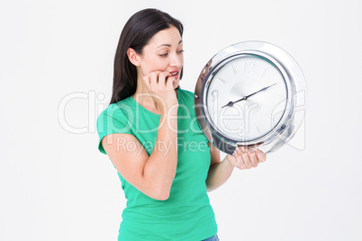 Brunette looking at wall clock