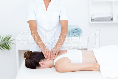 Physiotherapist doing neck massage Physiotherapist doing neck massage
