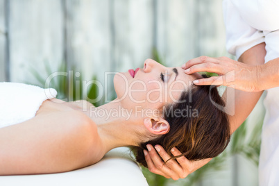 Brunette receiving head massage