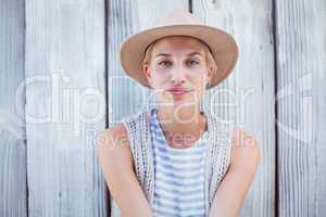 Pretty blonde woman wearing hat and smiling at camera
