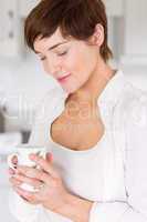 Pregnant woman having a hot drink
