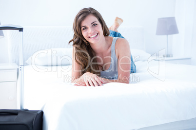 Happy woman with her case smiling at camera