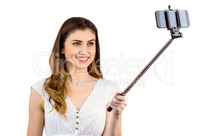 Pretty woman using a selfie stick