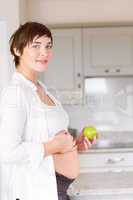 Pregnant woman holding an apple