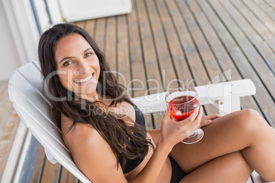 Beautiful woman relaxing and holding drink