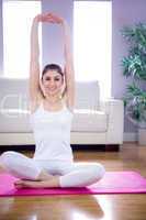 Fit woman doing yoga on mat