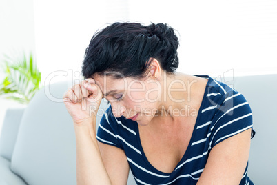 Unhappy woman sitting on the couch