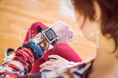 Slim woman looking at her smart watch