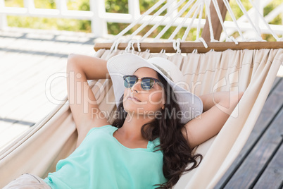 Pretty brunette relaxing on a hammock