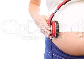 Pregnant woman holding earphones over bump