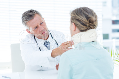 Doctor checking neck brace of his patient