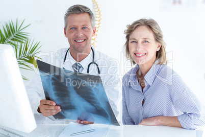 Doctor and patient smiling at camera