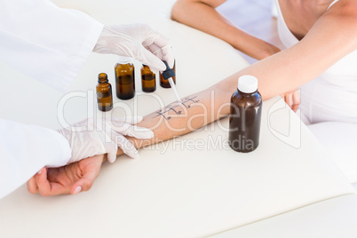 Doctor doing skin prick test at her patient