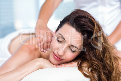 Smiling brunette getting back massage