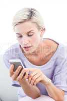 Pretty blonde woman texting with her mobile phone