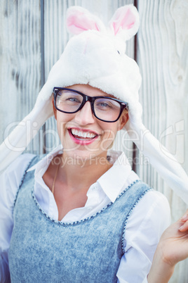 Pretty blonde woman smiling at the camera wearing funny hat