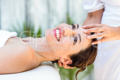 Brunette receiving head massage