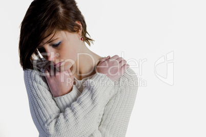 Sad pretty brunette thinking with arms crossed