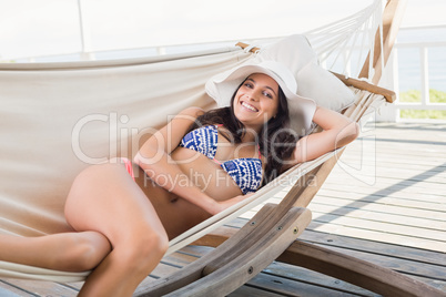 Pretty brunette relaxing on a hammock