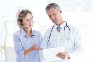 Doctor showing his notes to his patient