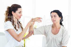Therapist holding her patients arm