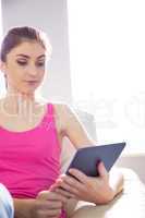 Casual woman using her tablet pc
