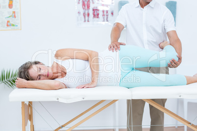 Doctor stretching his patients leg