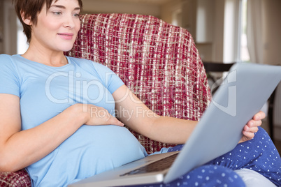 Pregnant woman using her laptop