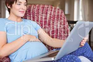 Pregnant woman using her laptop