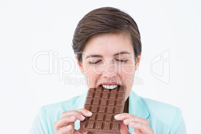 Brunette eating bar of chocolate