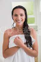 Pretty brunette holding her bath towel